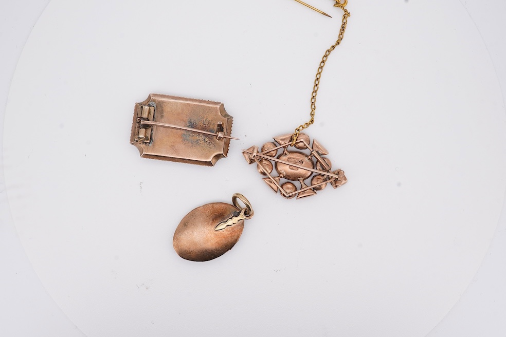 Three assorted Victorian brooches including a 9ct and garnet cluster by Murrle Bennett & Co, 27mm, a micro mosaic bar brooch and a yellow metal and split pearl mourning brooch, together with a gem set oval pendant. Condi